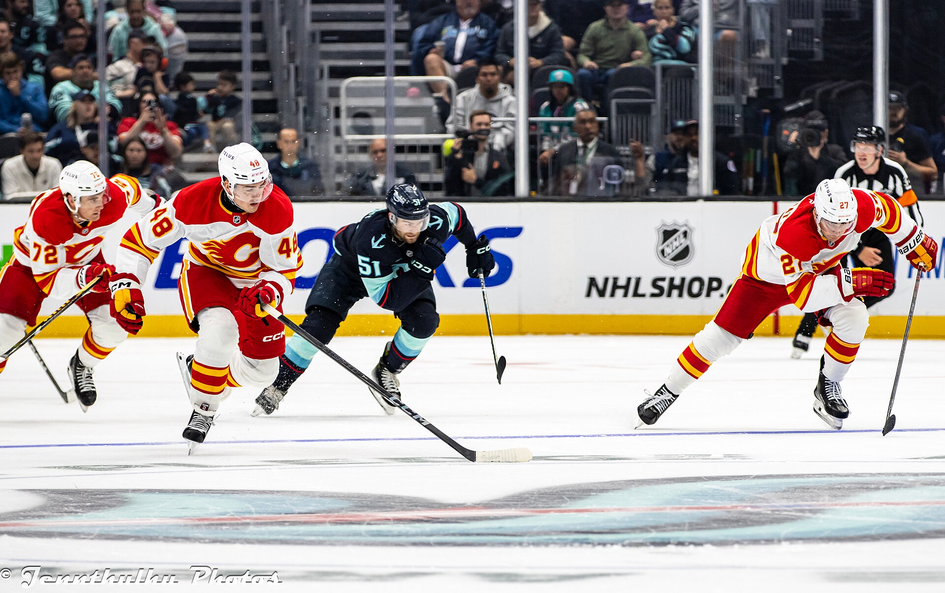 Matt Coronato and other Calgary Flames and Seattle Kraken players on the ice during a 2024 preseason game