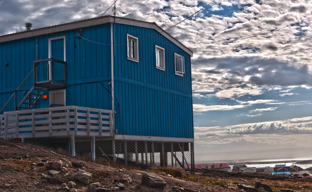 Blue residential home elevated on stilts in Nunavut